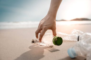 Environment, Ecology Care, Renewable Concept. Volunteer or Traveller Collecting Plastic Bottle Waste on the Beach Sand. Keep Beach Clean