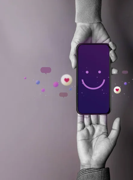 Customer Experience Concept. Happy Client giving a Smiling Emoticon via Mobile Phone to Brand. Feedback on Smartphone. Positive Review. Online Satisfaction Survey
