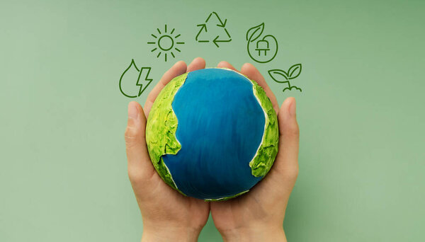 Earth in hands symbolizing sustainability, Recyling and Renewable, environmental care, Responsible Business, Top View
