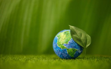 Globe with Green Leaf on Green Nature background. Environmental sustainability, Earth Day, global ecological care and Healthy planet