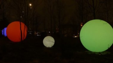 Parkta hafif modern kurulum. Üç büyük renkli küre. Kamusal alanda çağdaş sanat.