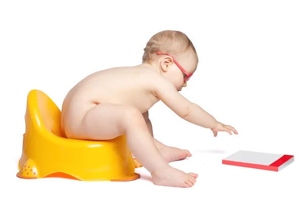 Little baby with glasses sitting on the toilet — Stock Photo, Image