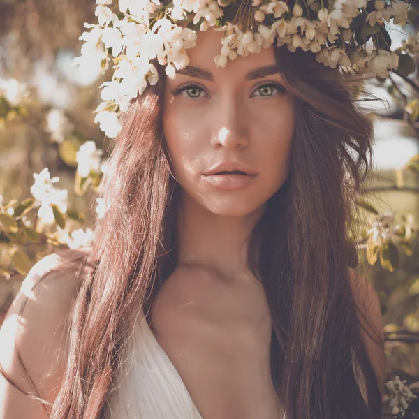 Romantic lady in a wreath of apple trees — Stock Photo, Image