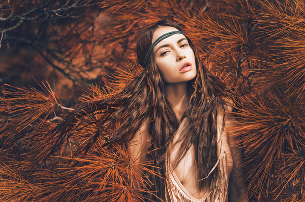 Outdoor fashion photo of beautiful lady hippie in a fir forest