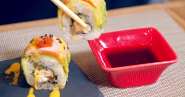Close Shot Bamboo Chopsticks Holding Delicious Roll Avocado Salmon Caviar — Stock Video
