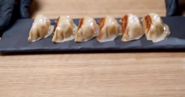 Close-up shot of delicious fried gyoza dumplings on a plate. — Stock Video