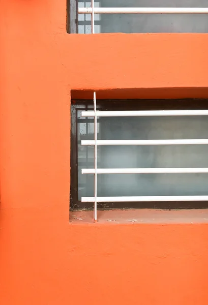 Barras de janela parede laranja — Fotografia de Stock