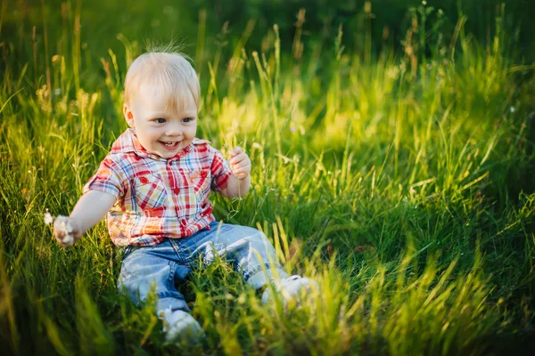 Child sitting on the grass Stock Picture