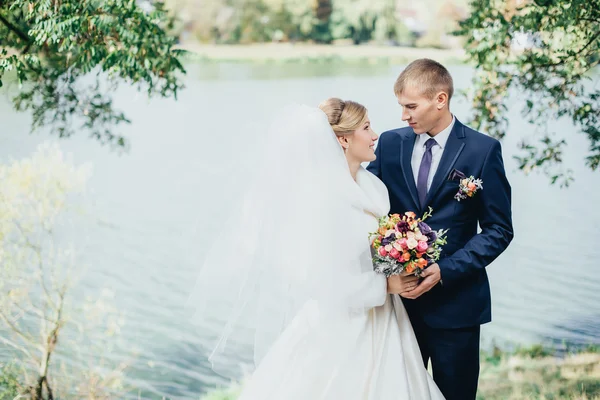 Bruid en bruidegom in de buurt van de rivier — Stockfoto