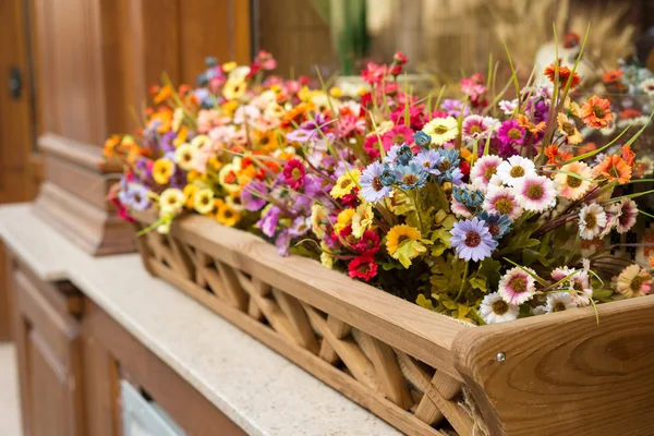 Artificial flowers in the box outside the window — Stock Photo, Image