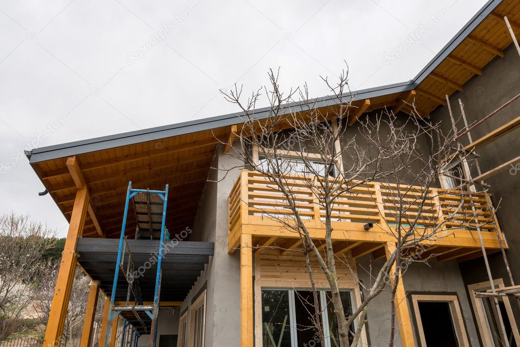 Scaffolding at the construction site of a new wooden house