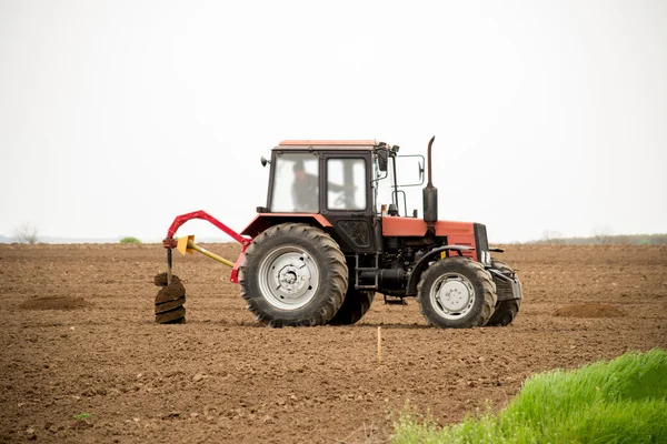 Tractor digging holes for tree planting — Stock Photo, Image