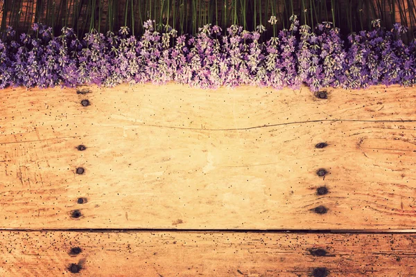 frame of lavender on a rustic wooden background