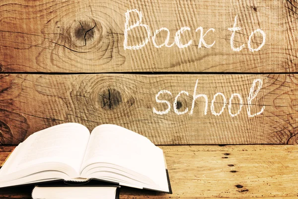 Back to school inscription with books over an rustic table — Stock Photo, Image
