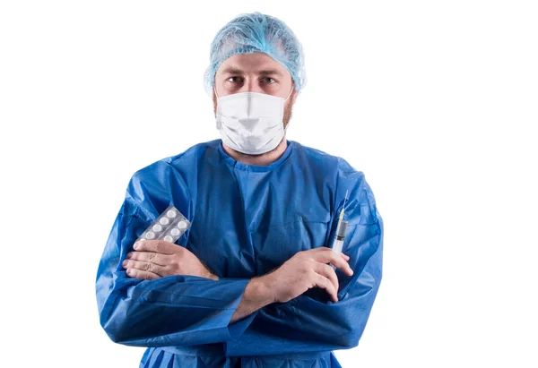 Medical doctor with pills in one hand and syringes in other — Stock Photo, Image