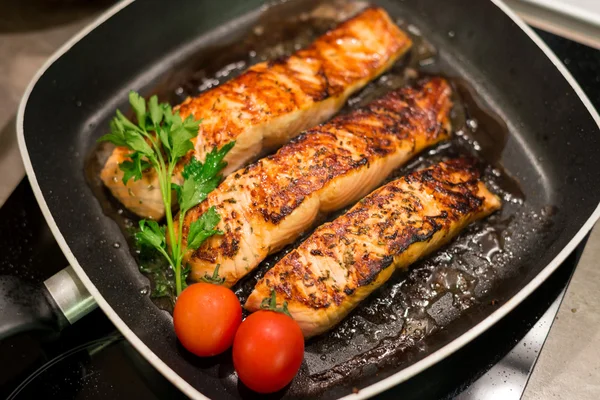 Fresh salmon filles  grilled in a pan — Stock Photo, Image