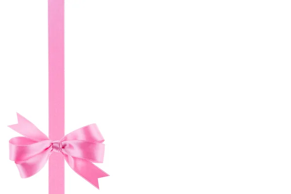 Розовая лента с луком на белом фоне — стоковое фото