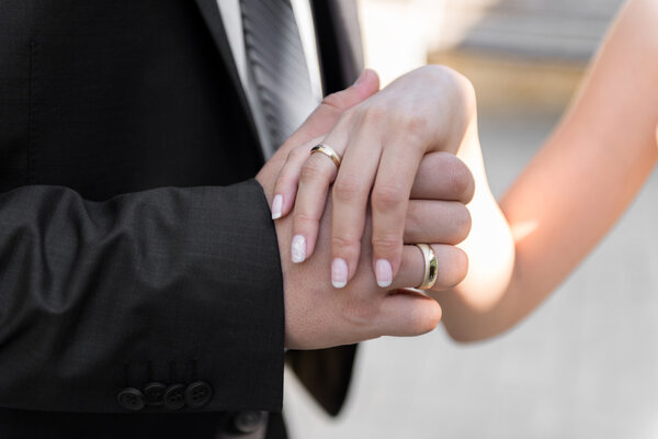 Couple holding hands - selective focus