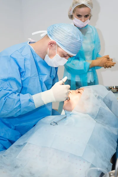 Dentists during surgery for implant placement — Stock Photo, Image