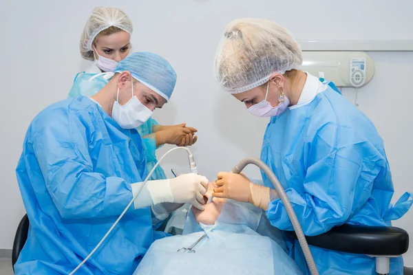 Dentists during surgery for implant placement — Stock Photo, Image