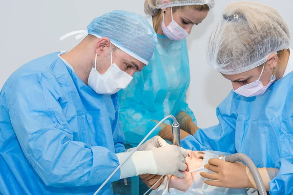 Dentists during surgery for implant placement — Stock Photo, Image