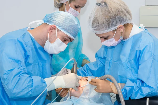 Dentists during surgery for implant placement — Stock Photo, Image