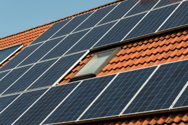 Solar panel on a red roof  clipart