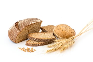 Variety of bread and stalks of wheat isolated on white