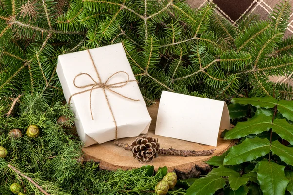 Christmas decoration with fir branches, mistletoe, wood and gifts - copy space — Zdjęcie stockowe