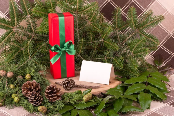 Christmas decoration with fir branches, mistletoe, wood and gifts - copy space — Stock Photo, Image