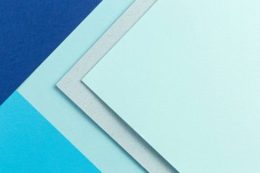 Malzeme tasarımı mavi arkaplan. Kağıt kağıtlar farklı şekillerde katlanır. Bir fotoğraf.