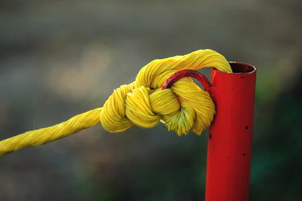 Желтая веревка на красной трубе — стоковое фото