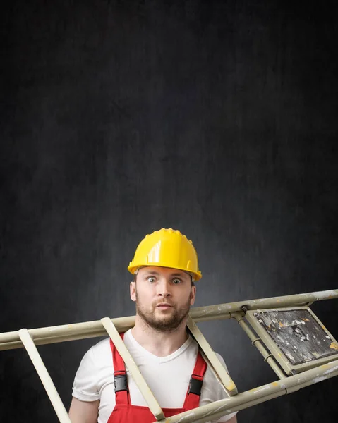 Portrait of a clumsy worker with ladder — Stock Photo, Image