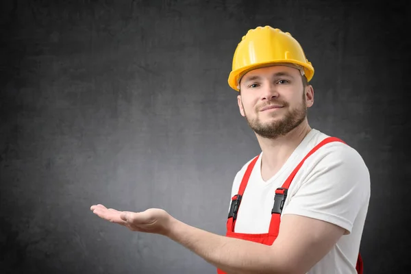 Worker looking at camera, and showing copy space with his hand — Stock Photo, Image