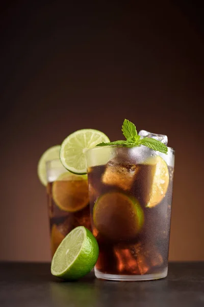 Cuba Libre cocktail. Alcoholic drink with cola, rum, lime and mint. Cuba Libre or long island iced tea cocktail.