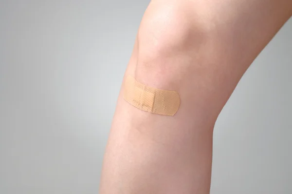 Plaster on female leg — Stock Photo, Image