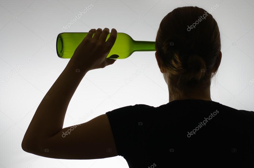 Silhouette of an alcoholic with a bottle