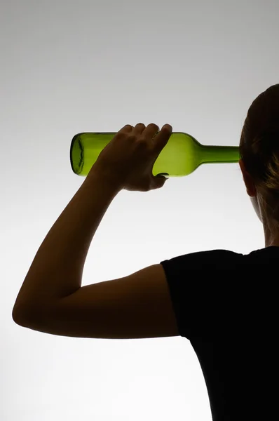 Silhouette of an alcoholic woman with a bottle — Stock Photo, Image