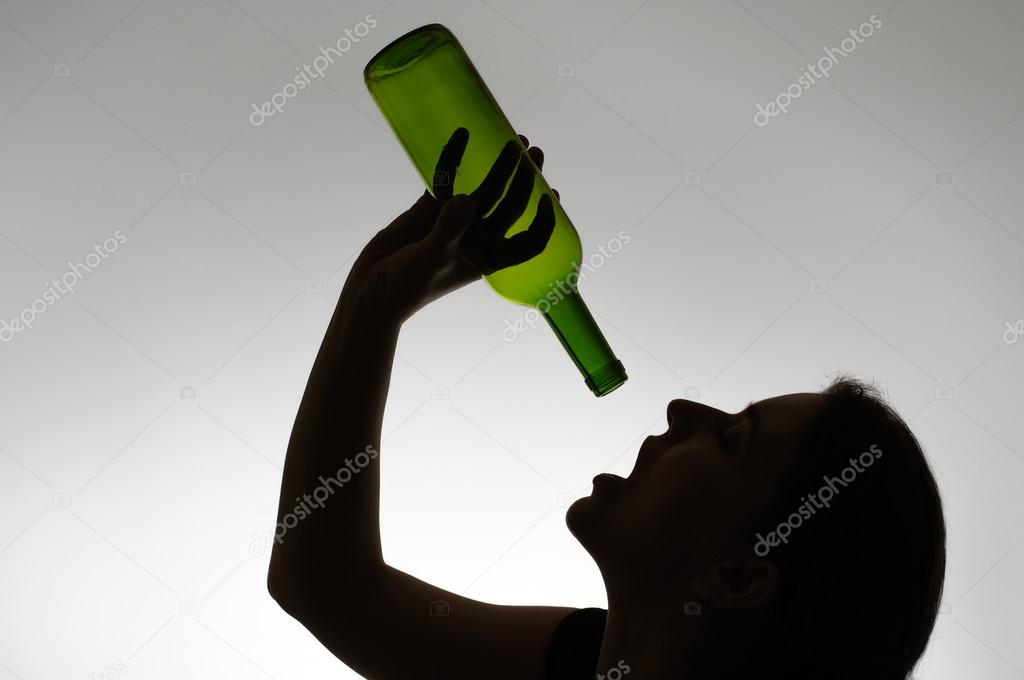 Silhouette of an alcoholic woman with a bottle