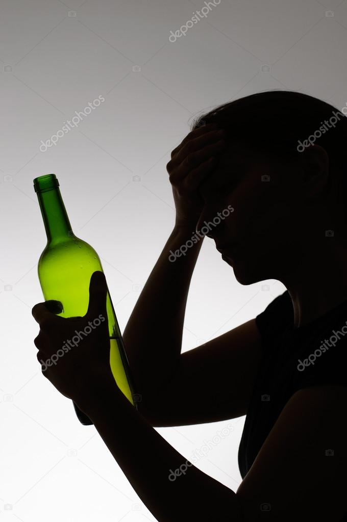 Silhouette of a sad drinker