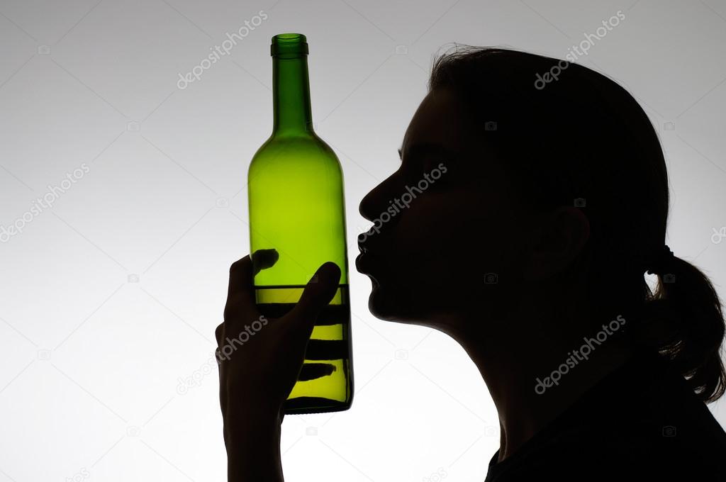 Alcoholic woman kissing a wine bottle