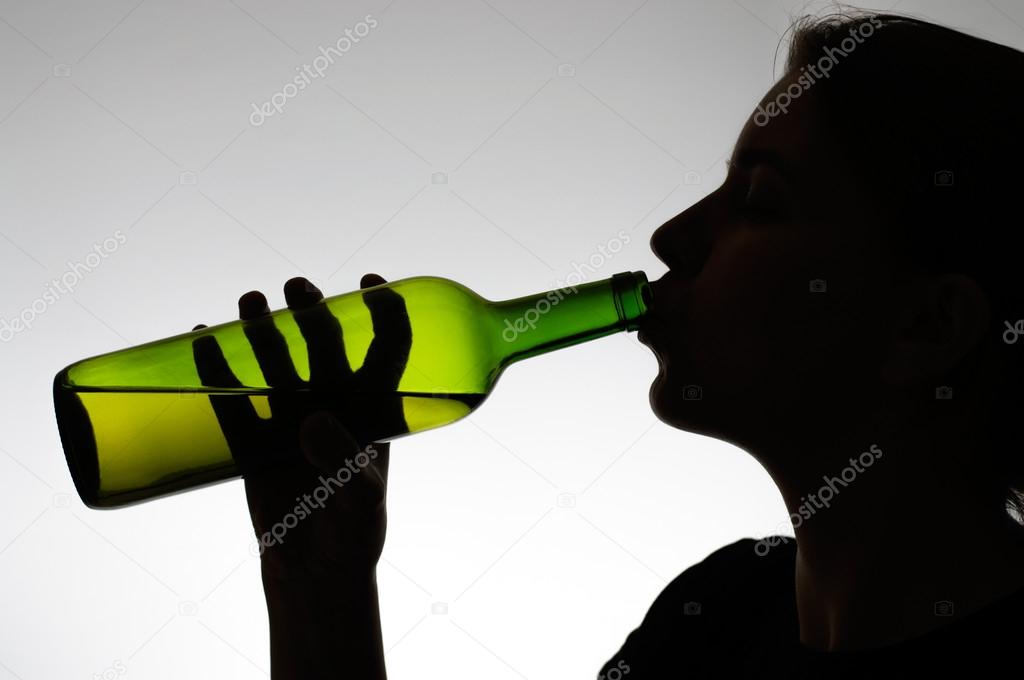 Alcoholic woman drinking from a bottle