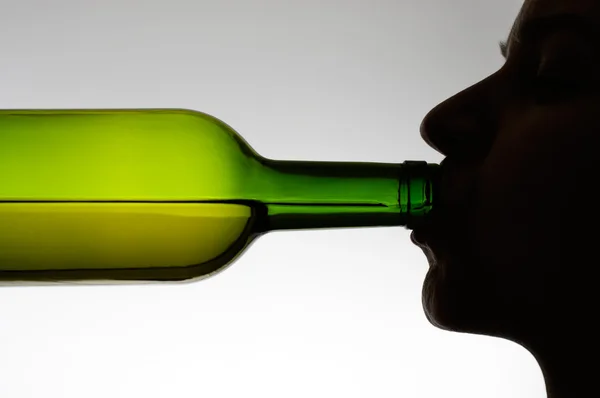 Woman drinking from a bottle — Stock Photo, Image