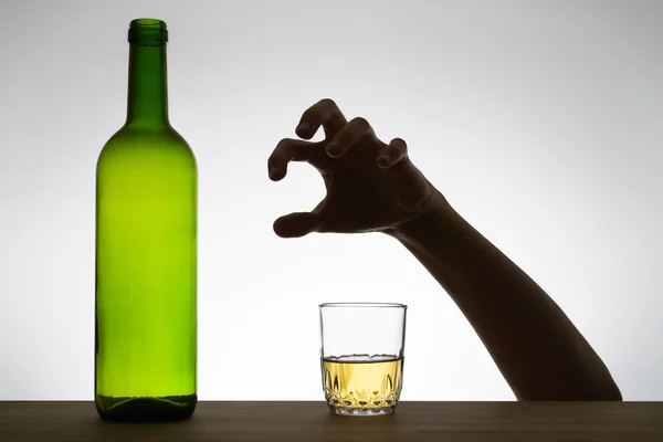 Hand reaching for a glass of wine — Stock Photo, Image