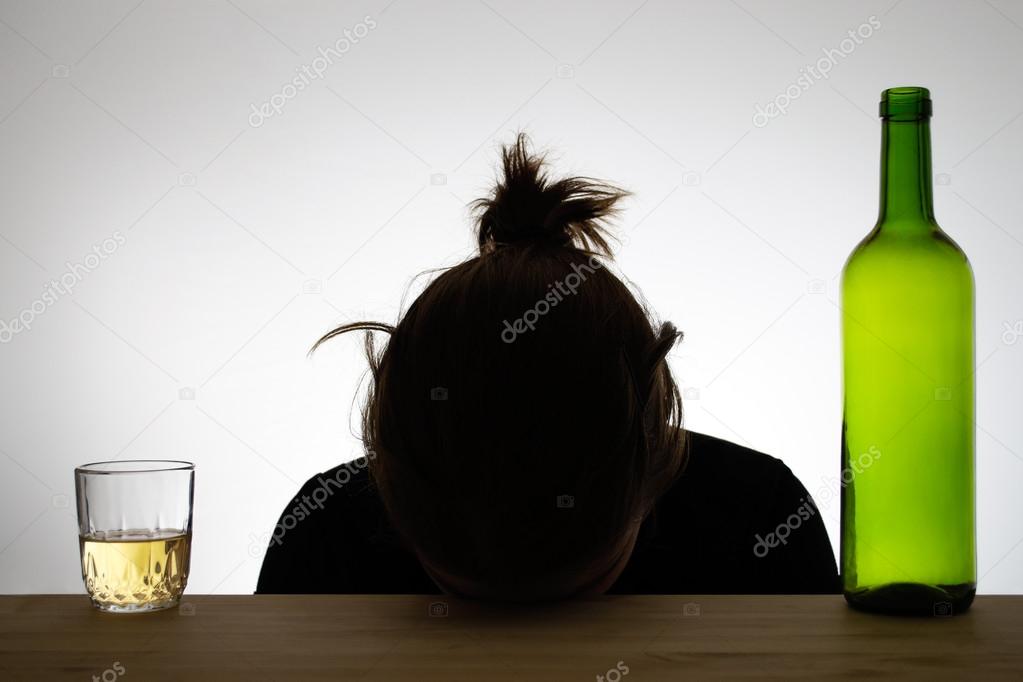 Silhouette of a drunk woman sleeping on a desk