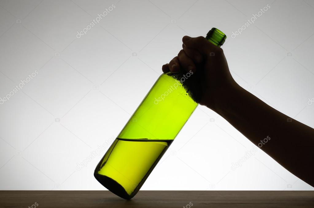 Female hand grabbing a bottle