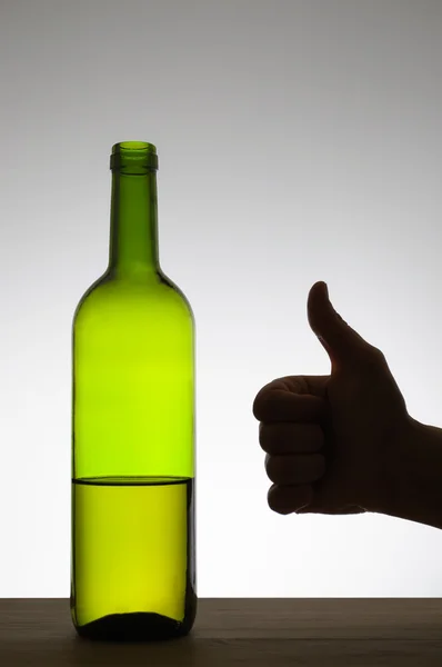 Thumbs up sign and a bottle of wine — Stock Photo, Image