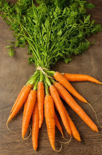 Fresh carrots on wooden table — Stock Photo, Image