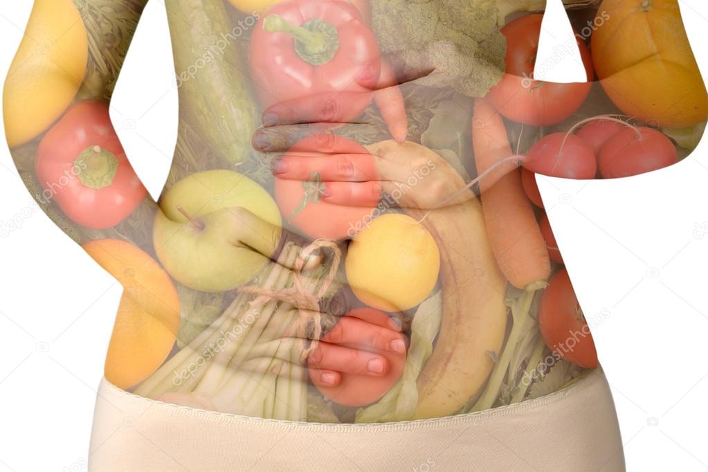 Female abdomen with fruits and vegetables isolated on white