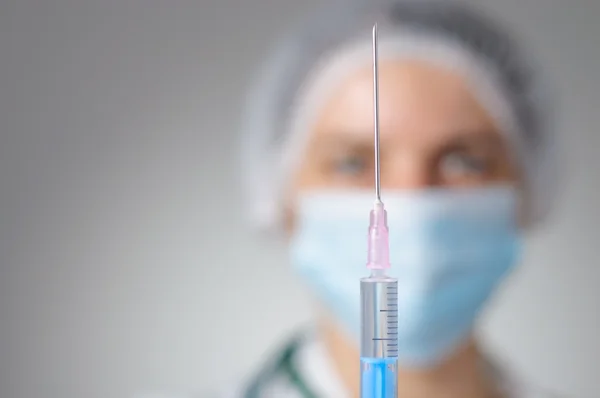 Female doctor with syringe — Stock Photo, Image